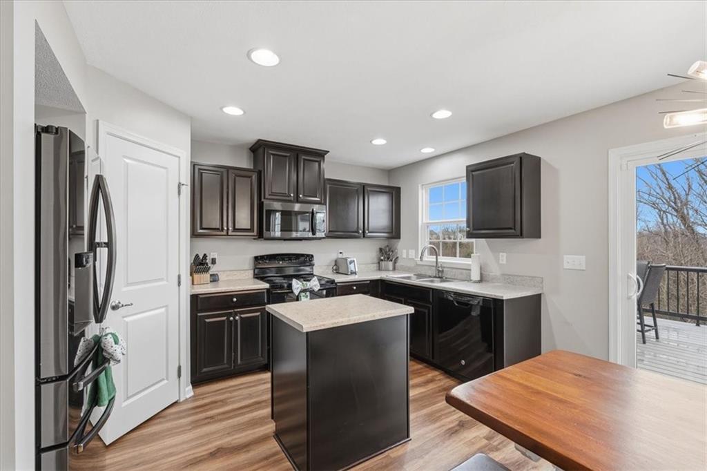 235 Long Ridge Drive Coraopolis, PA 15108 - Photo 11 of 36 a kitchen with stainless steel appliances granite countertop a sink stove refrigerator and cabinets