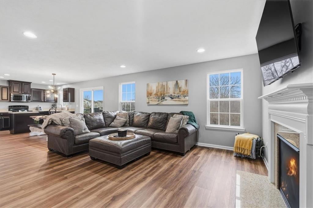 235 Long Ridge Drive Coraopolis, PA 15108 - Photo 6 of 36 a living room with furniture a fireplace and a flat screen tv
