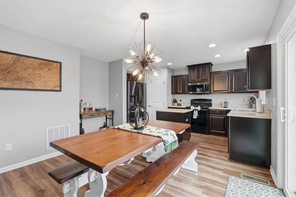 235 Long Ridge Drive Coraopolis, PA 15108 - Photo 9 of 36 a large kitchen with kitchen island a stove a sink a refrigerator and a dining table