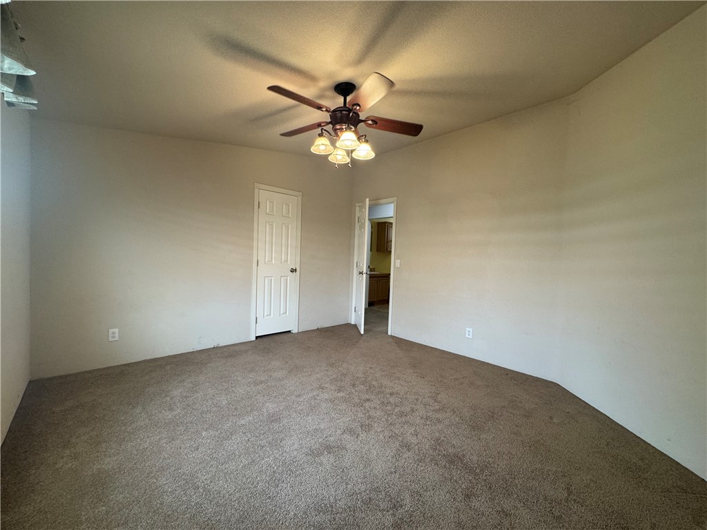 10044 Kent Road Mohave Valley, AZ 86440 - Photo 12 of 25 Unfurnished bedroom with carpet and a ceiling fan