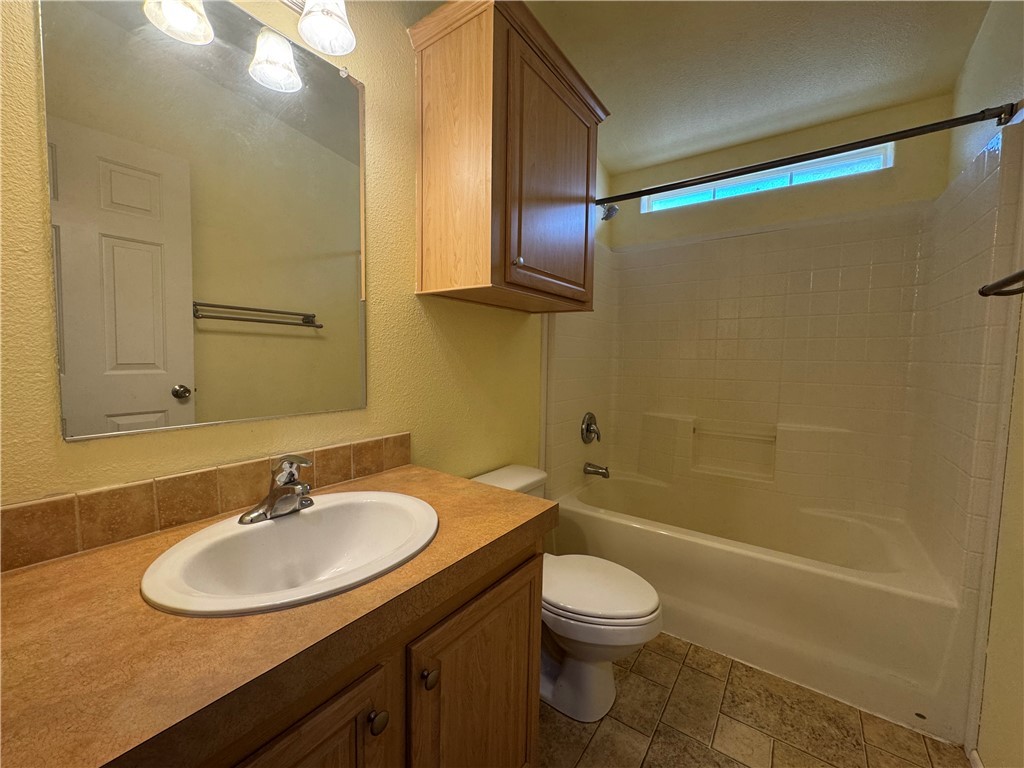 10044 Kent Road Mohave Valley, AZ 86440 - Photo 13 of 25 Bathroom featuring a textured wall, vanity, and shower / bathtub combination
