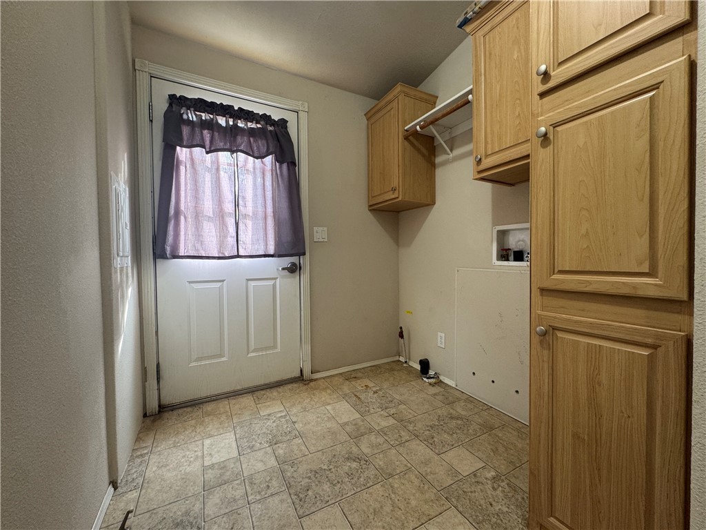 10044 Kent Road Mohave Valley, AZ 86440 - Photo 15 of 25 Laundry room with light stone finish floors, washer hookup, and cabinet space