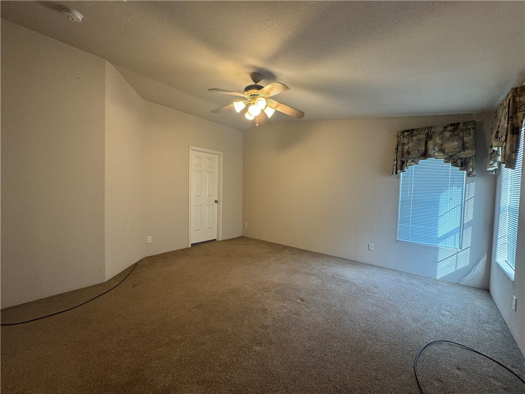 10044 Kent Road Mohave Valley, AZ 86440 - Photo 17 of 25 Empty room featuring carpet flooring, a textured ceiling, and ceiling fan
