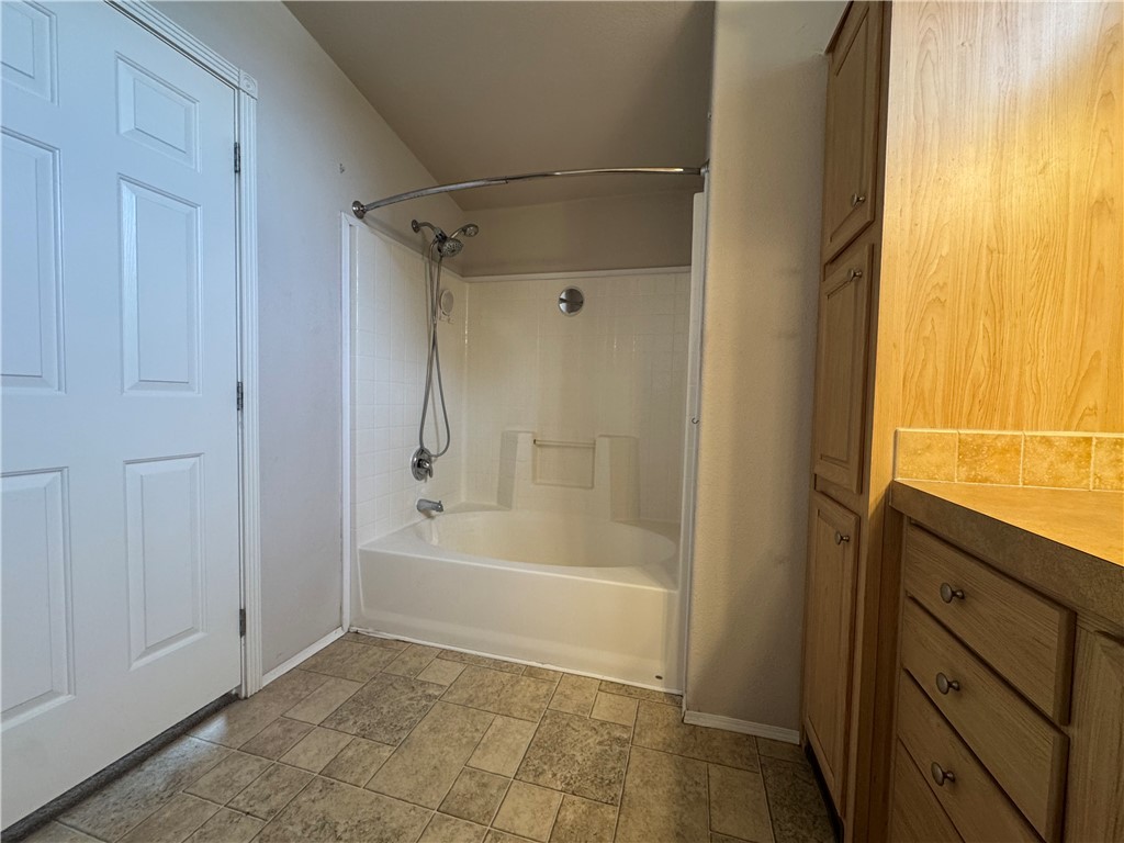 10044 Kent Road Mohave Valley, AZ 86440 - Photo 19 of 25 Full bathroom featuring bathtub / shower combination, vanity, and stone finish flooring