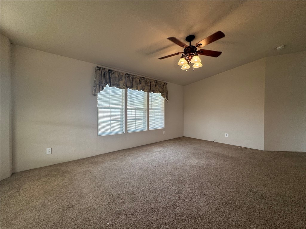 10044 Kent Road Mohave Valley, AZ 86440 - Photo 5 of 25 Spare room featuring carpet and a ceiling fan