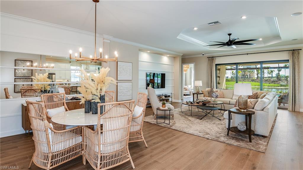 15680 Cassio Way Naples, FL 34114 - Photo 16 of 36 a living room with lots of furniture and a chandelier