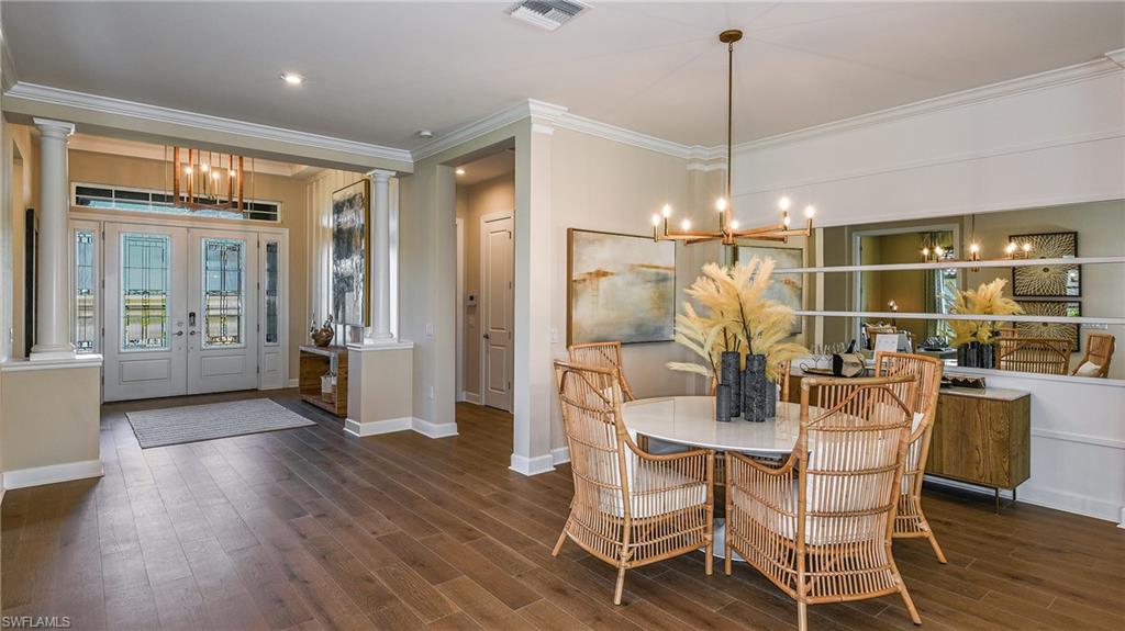 15680 Cassio Way Naples, FL 34114 - Photo 17 of 36 a dining room with furniture a chandelier and wooden floor