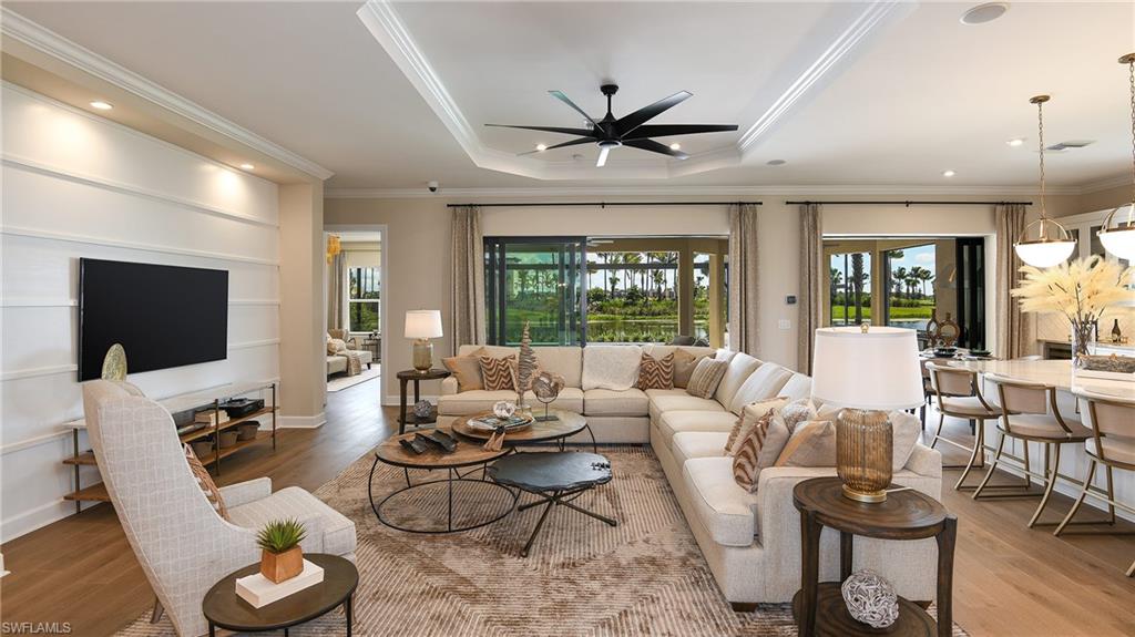 15680 Cassio Way Naples, FL 34114 - Photo 19 of 36 a living room with furniture a flat screen tv and a large window