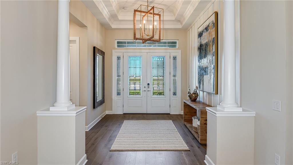 15680 Cassio Way Naples, FL 34114 - Photo 7 of 36 a view of a hallway with windows
