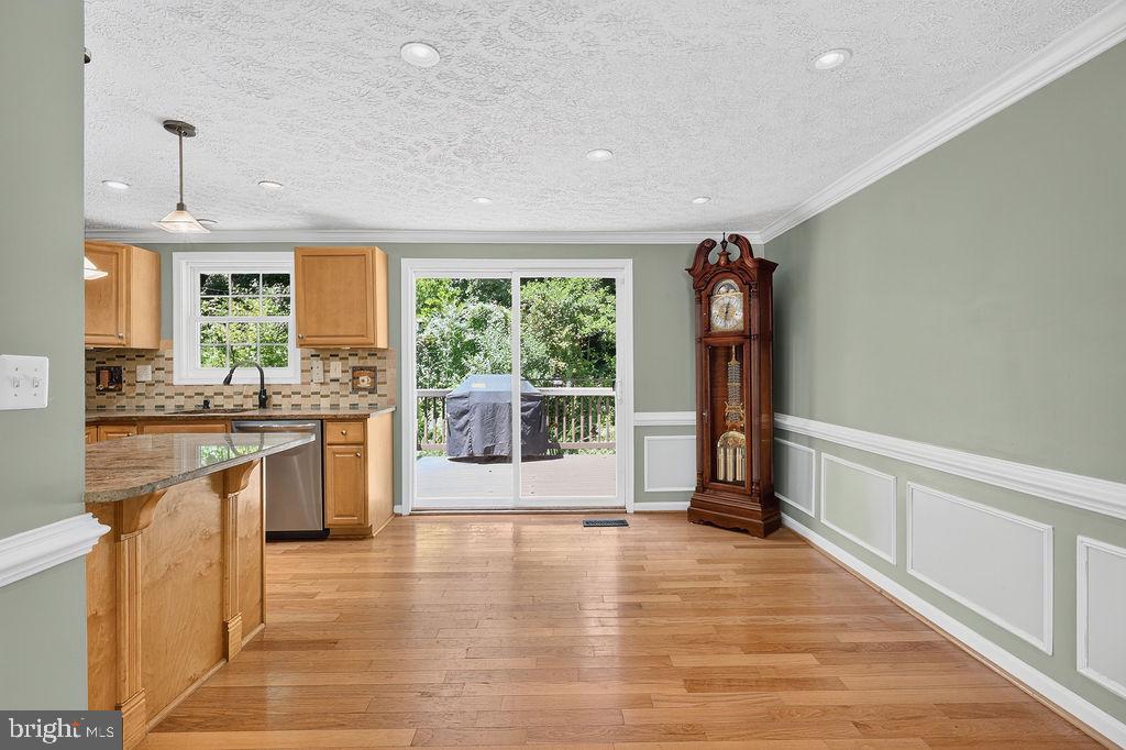 8471 Great Lake Lane Springfield, VA 22153 - Photo 65 of 65 a open kitchen with stainless steel appliances granite countertop a refrigerator a sink a stove and oven with wooden floors