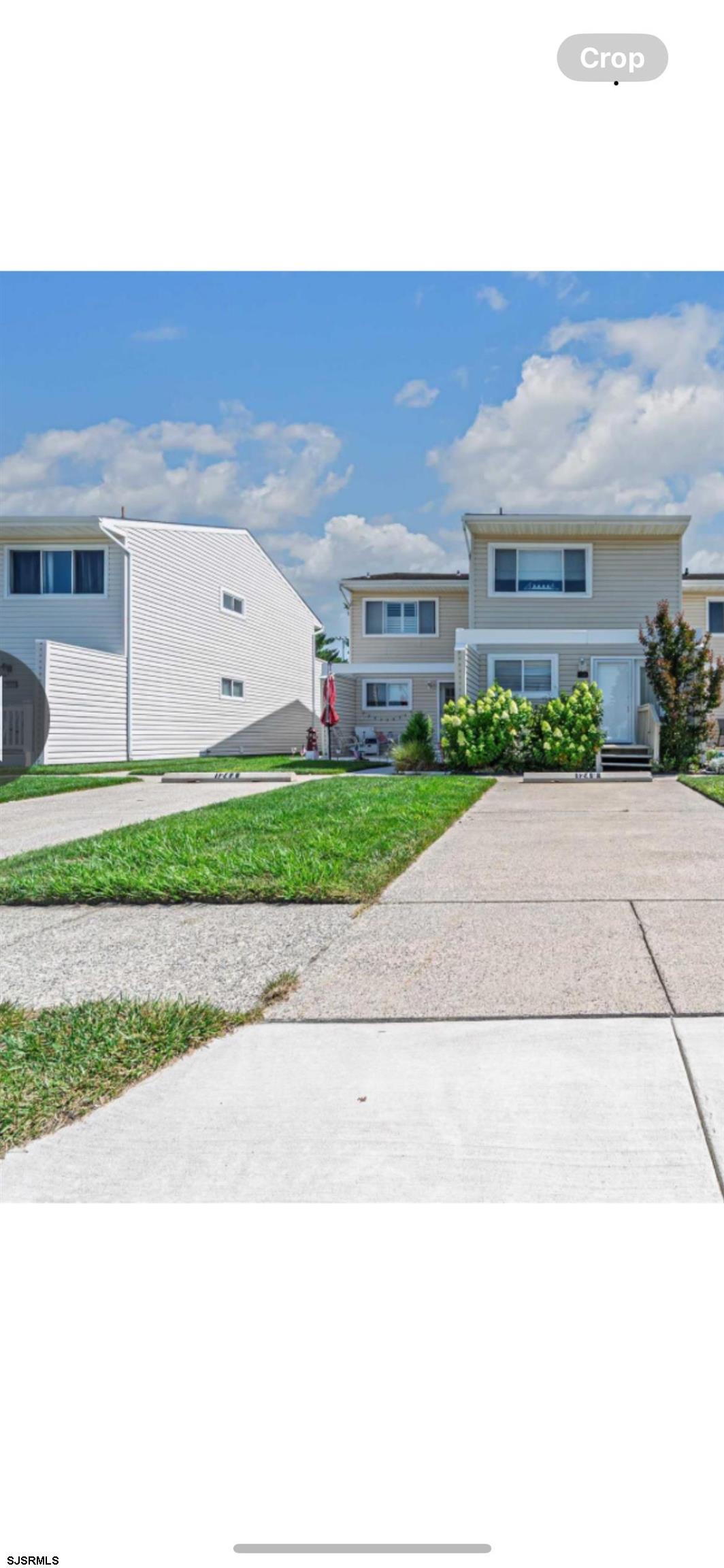 124 44th Street South, Unit B Brigantine, NJ 08203 - Photo 12 of 13 a front view of house with a yard and trees