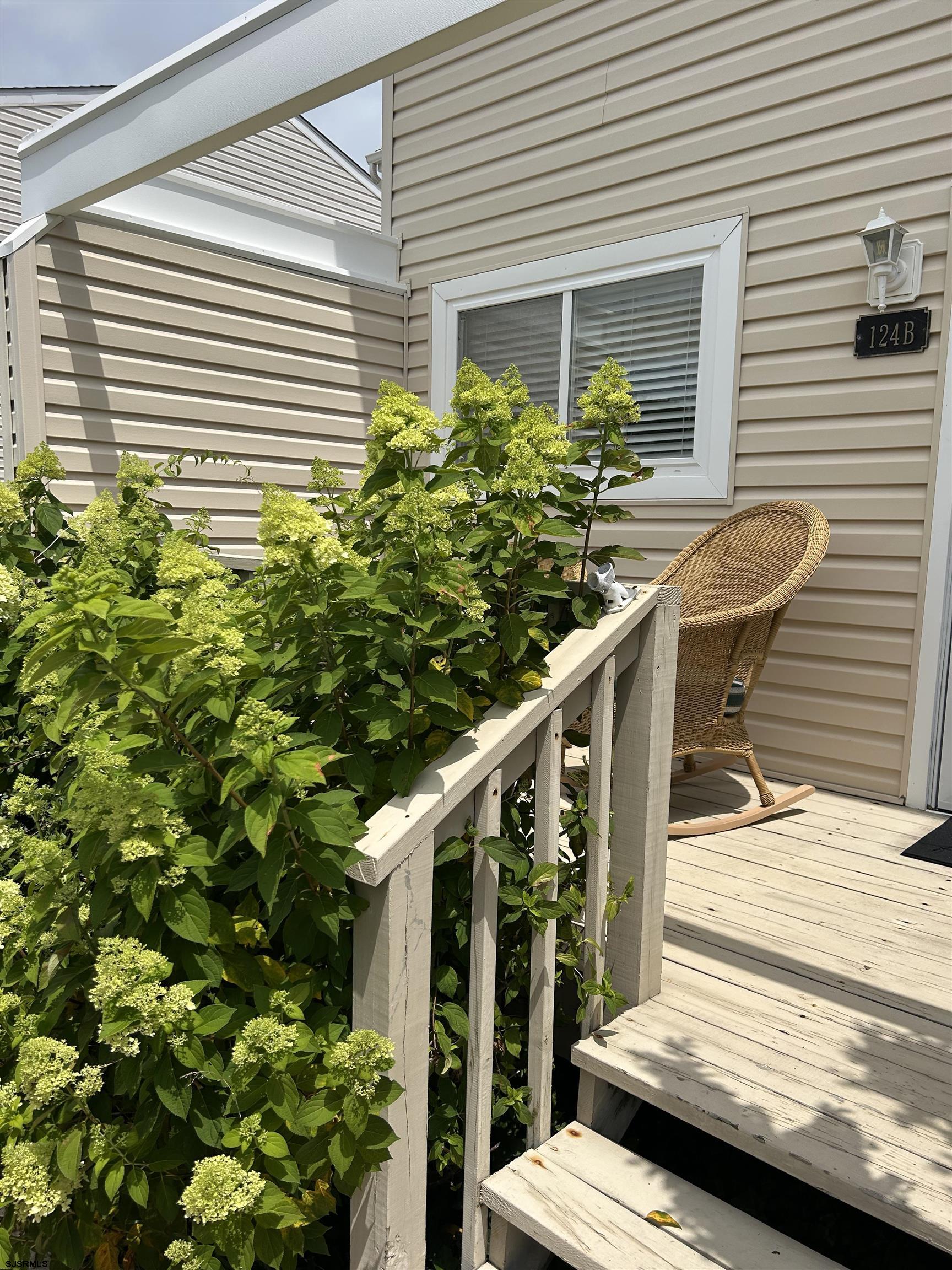 124 44th Street South, Unit B Brigantine, NJ 08203 - Photo 13 of 13 a balcony with potted plants and wooden bench
