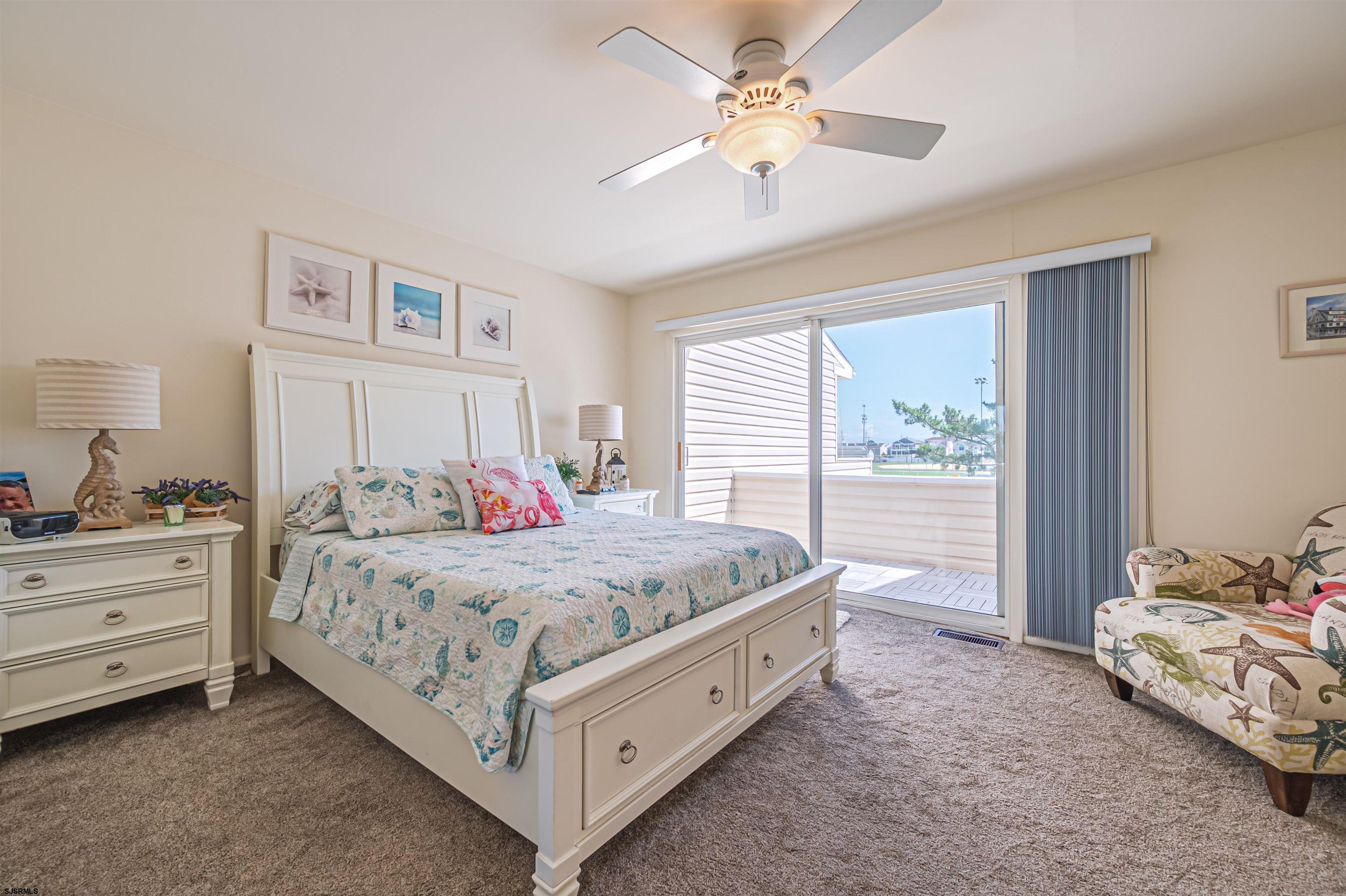 124 44th Street South, Unit B Brigantine, NJ 08203 - Photo 4 of 13 a spacious bedroom with a bed and a chandelier