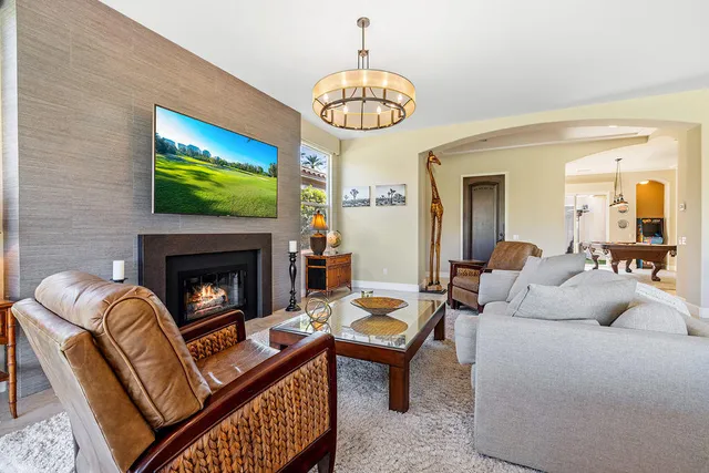 a living room with furniture a table and a fireplace