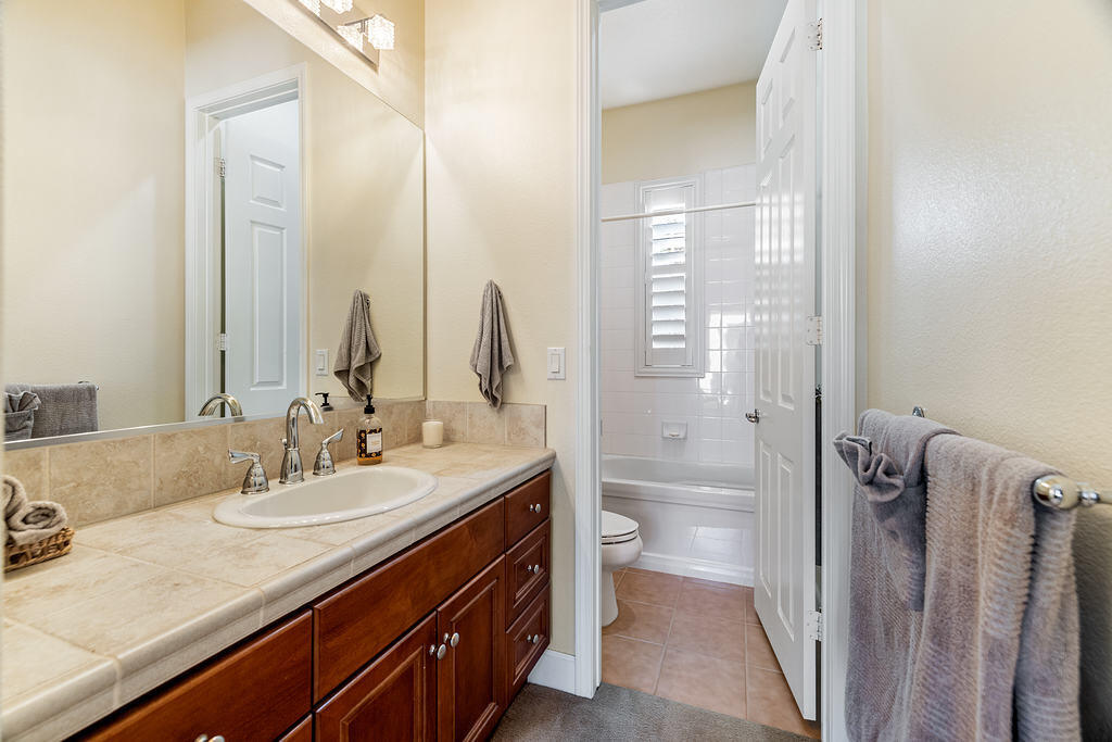 56825 Mountain View La Quinta, CA 92253 - Photo 15 of 30 a bathroom with a granite countertop sink a toilet and shower