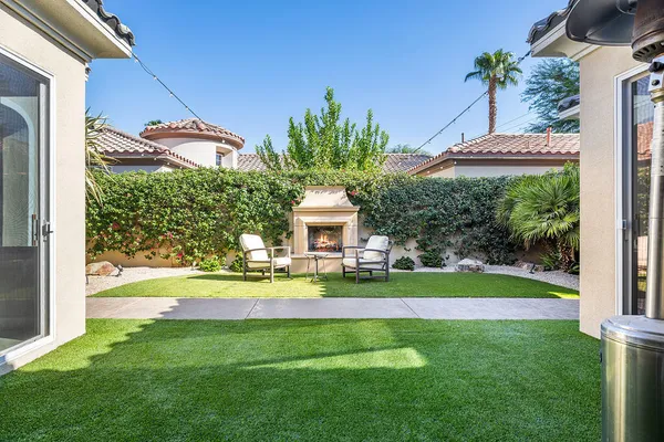 a front view of a house with a yard table and chairs