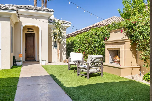 a front view of a house with garden and patio