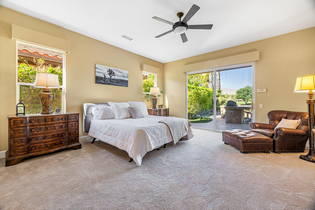 56825 Mountain View La Quinta, CA 92253 - Photo 19 of 30 a spacious bedroom with a bed couch and window