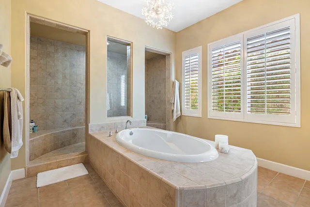 a bath tub sitting in a bathroom next to a window
