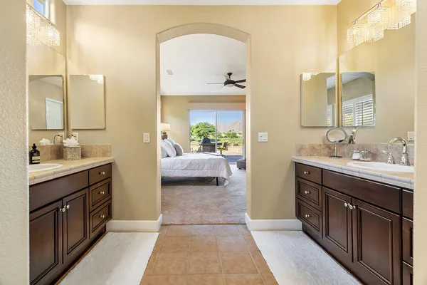 a en suite bathroom with a double vanity sink a mirror and a shower