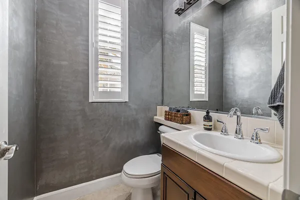 a bathroom with a sink toilet and a mirror