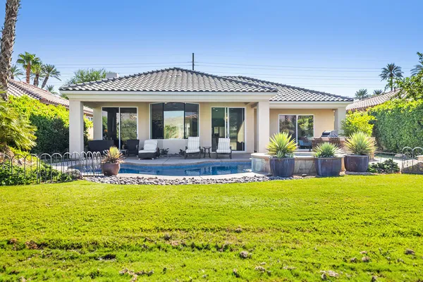 a view of a house with swimming pool having outdoor seating