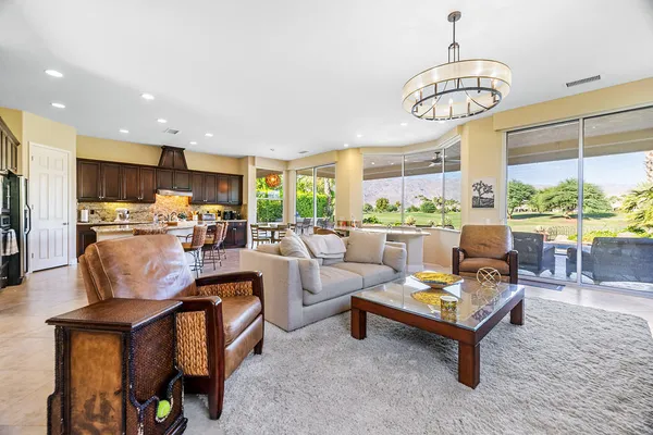 a living room with fireplace furniture and a chandelier