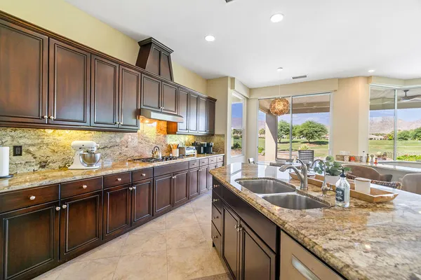 a kitchen with granite countertop a sink and a counter top space