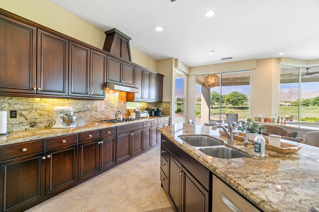 56825 Mountain View La Quinta, CA 92253 - Photo 8 of 30 a kitchen with granite countertop a sink and a counter top space