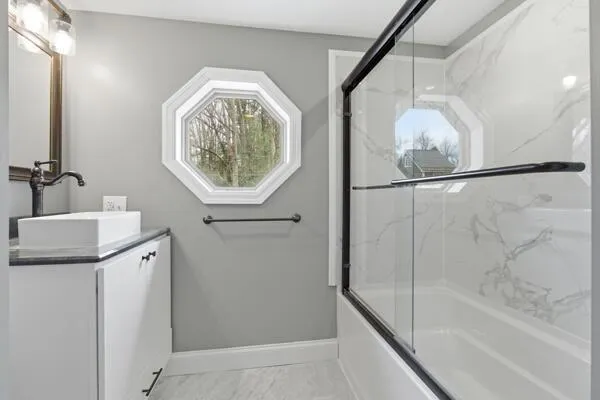a bathroom with a bathtub and a shower