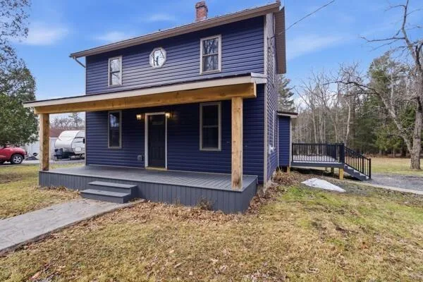 a view of a house with a wooden fence