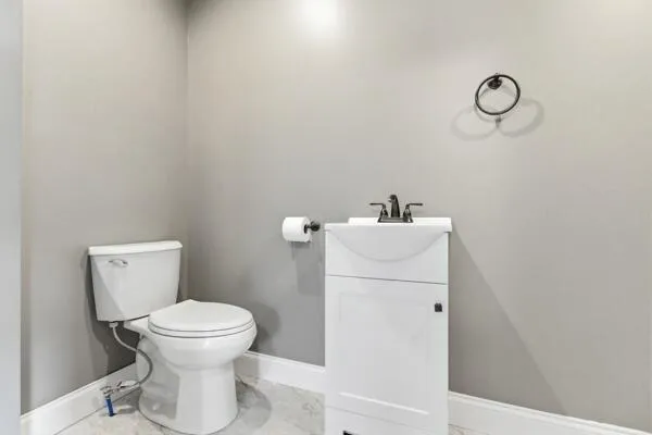a bathroom with a sink toilet and a mirror
