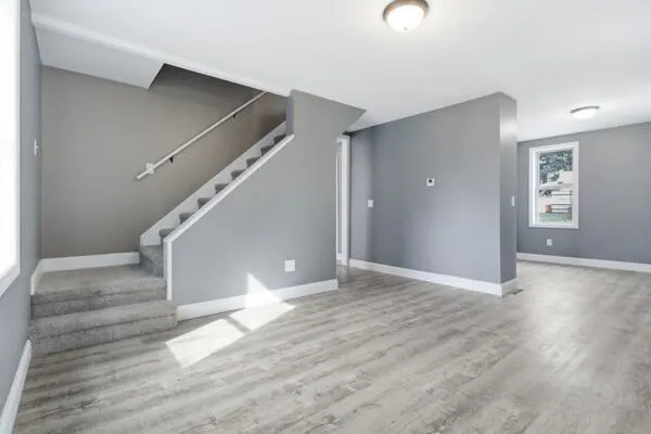 a view of entryway and hall with wooden floor