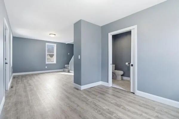 a view of a room with wooden floor and a bathroom