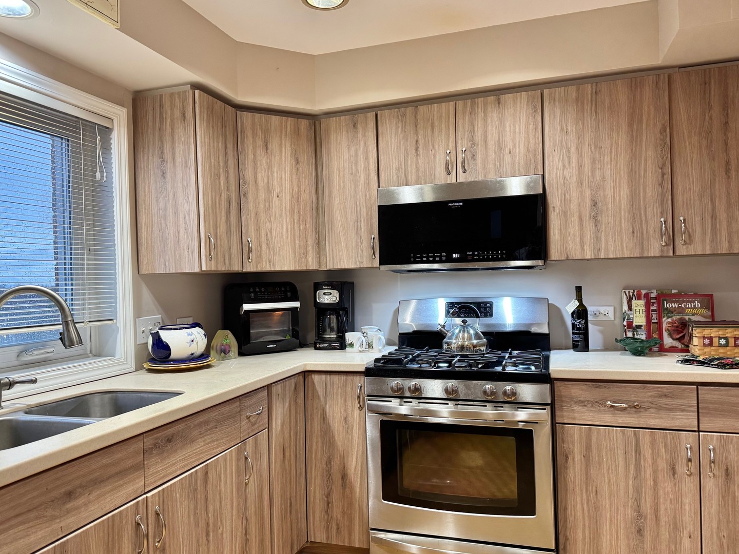 1325 Perry Street, Unit 606 Des Plaines, IL 60016 - Photo 20 of 25 a kitchen with granite countertop a sink a stove a microwave and cabinets