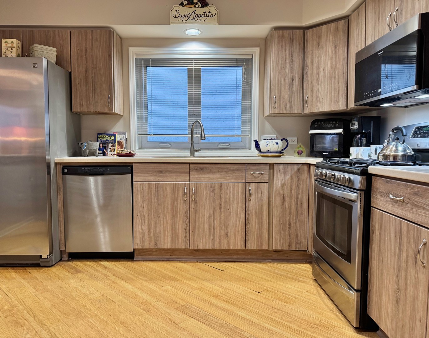 1325 Perry Street, Unit 606 Des Plaines, IL 60016 - Photo 4 of 25 a kitchen with stainless steel appliances granite countertop a stove a sink and a refrigerator