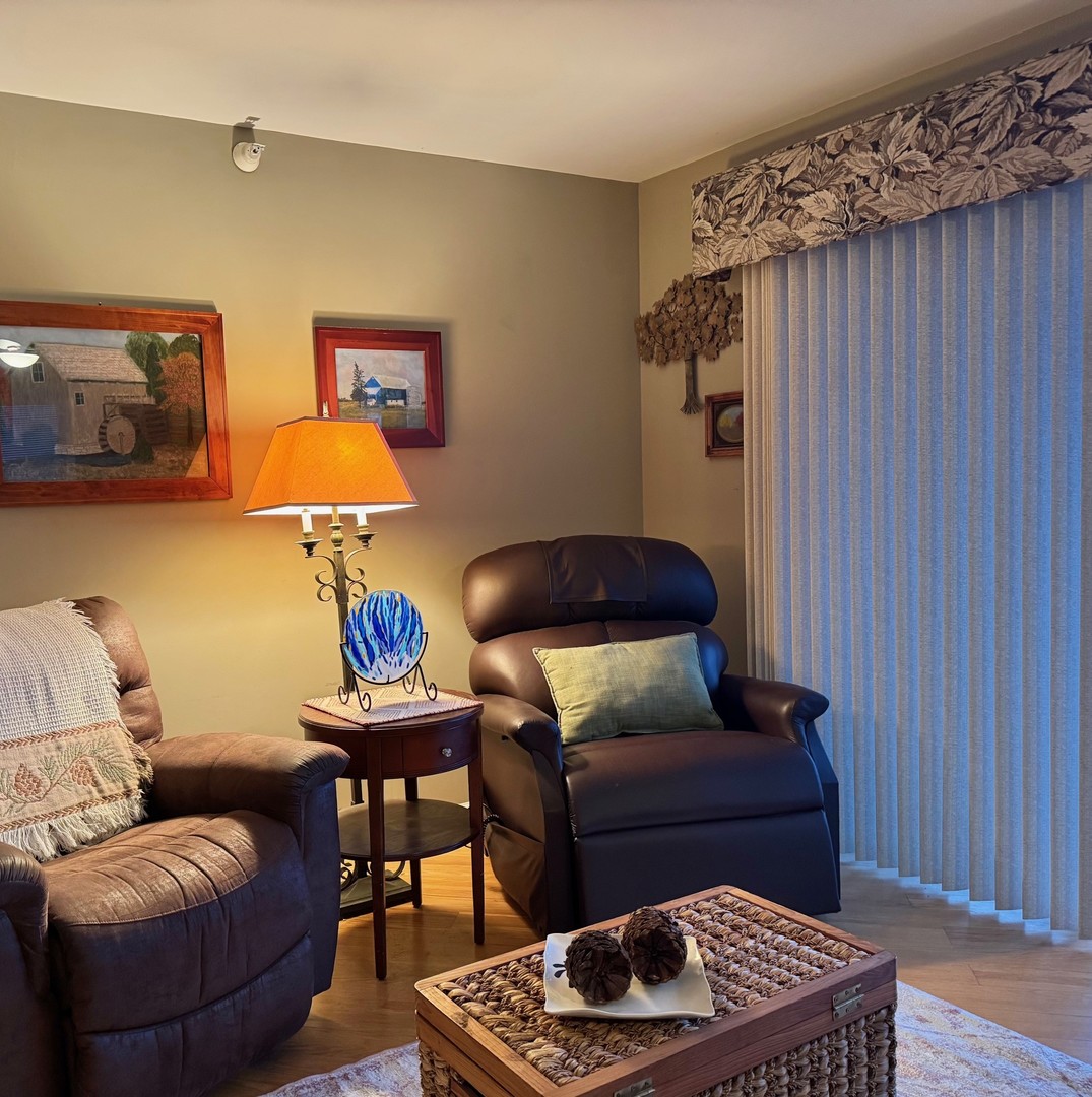 1325 Perry Street, Unit 606 Des Plaines, IL 60016 - Photo 9 of 25 a living room with furniture and a wooden floor