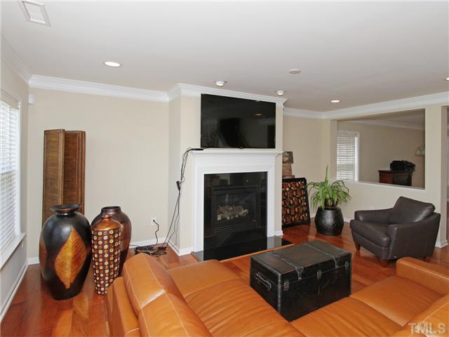 113 Poppy Hills Court Raleigh, NC 27603 - Photo 4 of 17 a bedroom with furniture and a fireplace