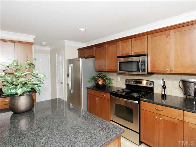 113 Poppy Hills Court Raleigh, NC 27603 - Photo 6 of 17 a kitchen with a sink a microwave and cabinets