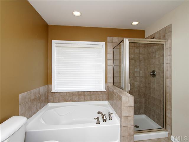 113 Poppy Hills Court Raleigh, NC 27603 - Photo 10 of 17 a bathroom with a bathtub and a shower