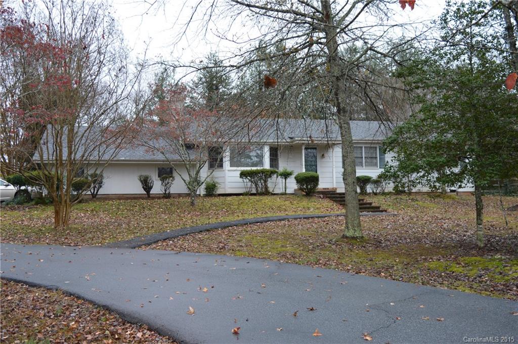 981 Red Fox Road, Unit 4 Columbus, NC 28722 - Photo 2 of 4 a front view of a house with a yard and garage