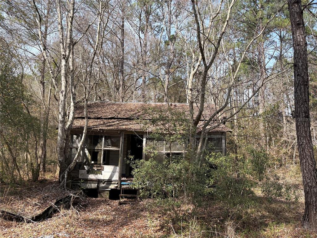 4385 Bondarenko Road Keystone Heights, FL 32656 - Photo 5 of 8 a front view of a house with garden and sitting area