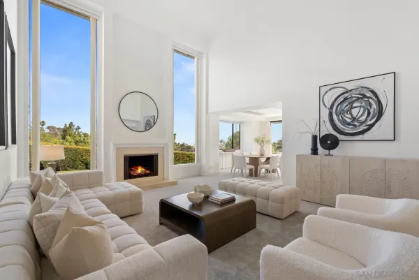 a living room with furniture a clock and a fireplace