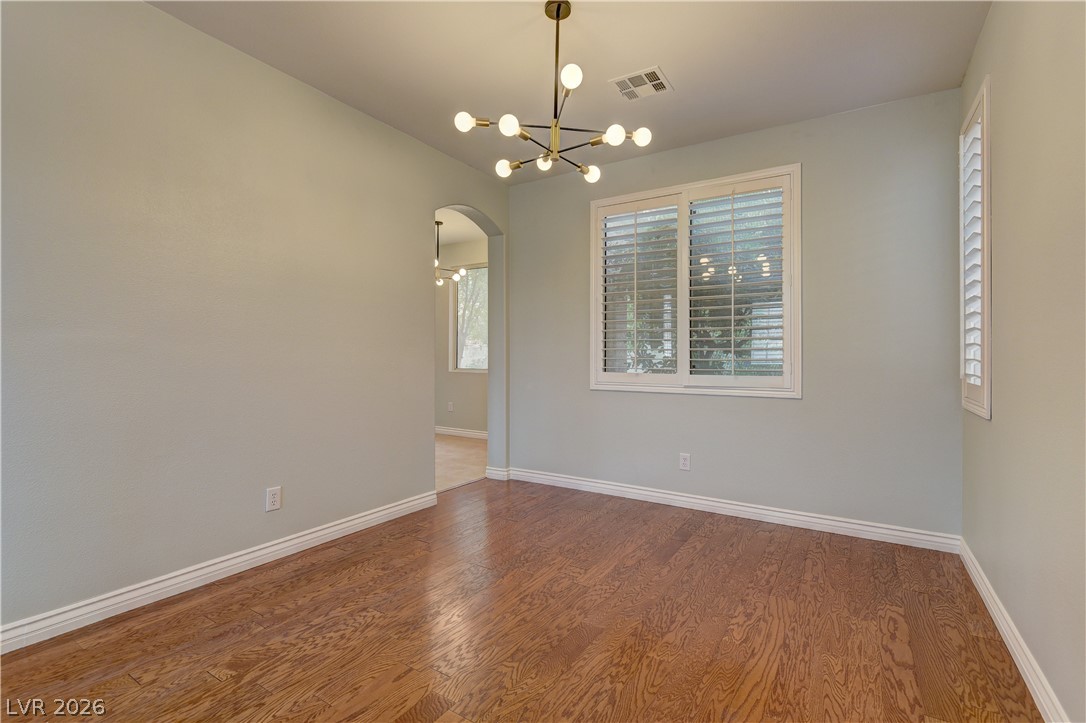 1813 Snow Spring Lane Las Vegas, NV 89134 - Photo 9 of 37 Hardwood flooring flows throughout this adaptable space, highlighted by an elegant chandelier.