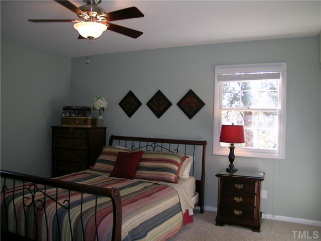 604 Purdue Street Raleigh, NC 27609 - Photo 8 of 12 a bedroom with a bed and a window