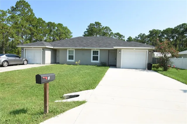 a front view of house with yard and green space