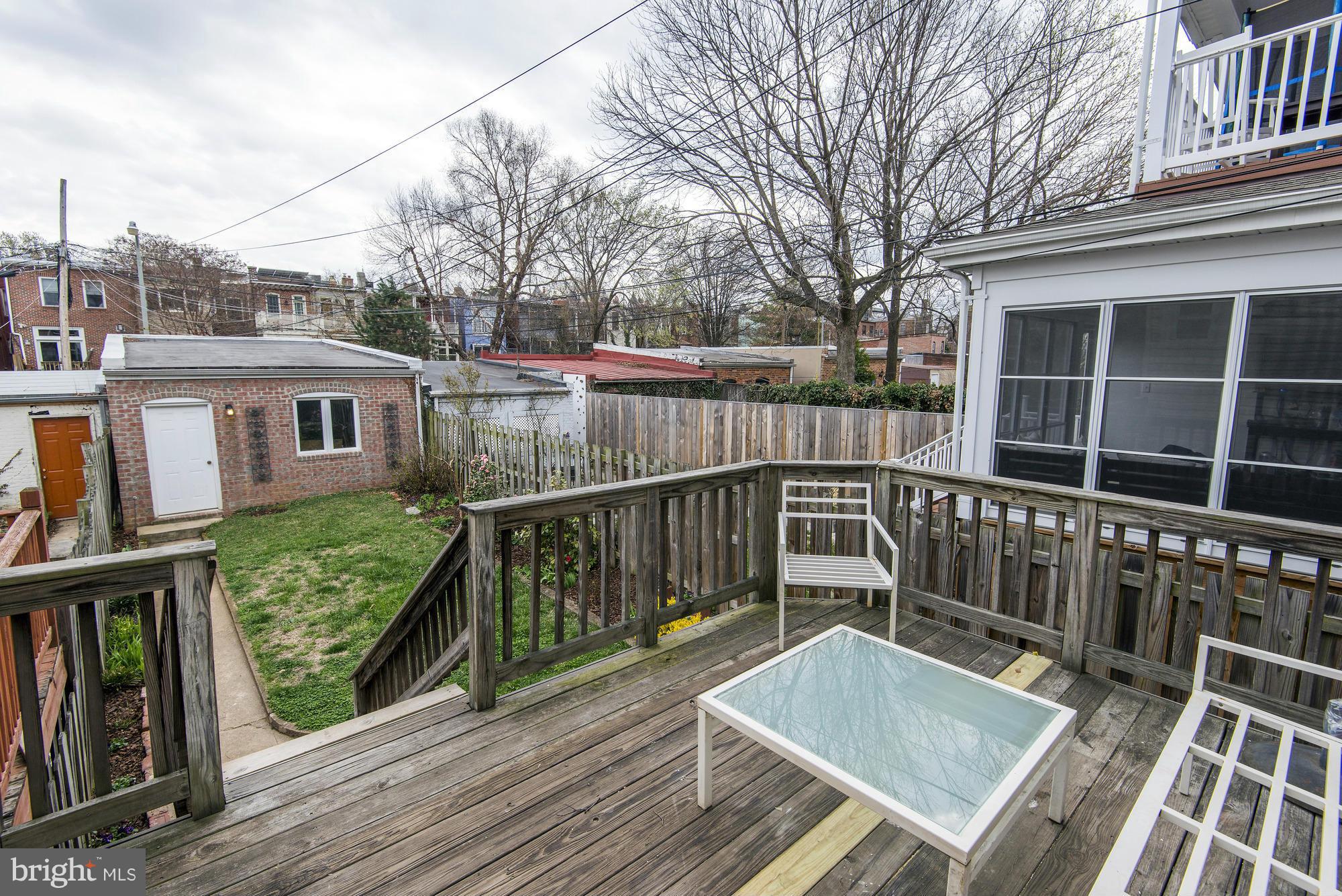 1351 A Street Northeast Washington, DC 20002 - Photo 12 of 26 a view of a deck with two chair and wooden floor