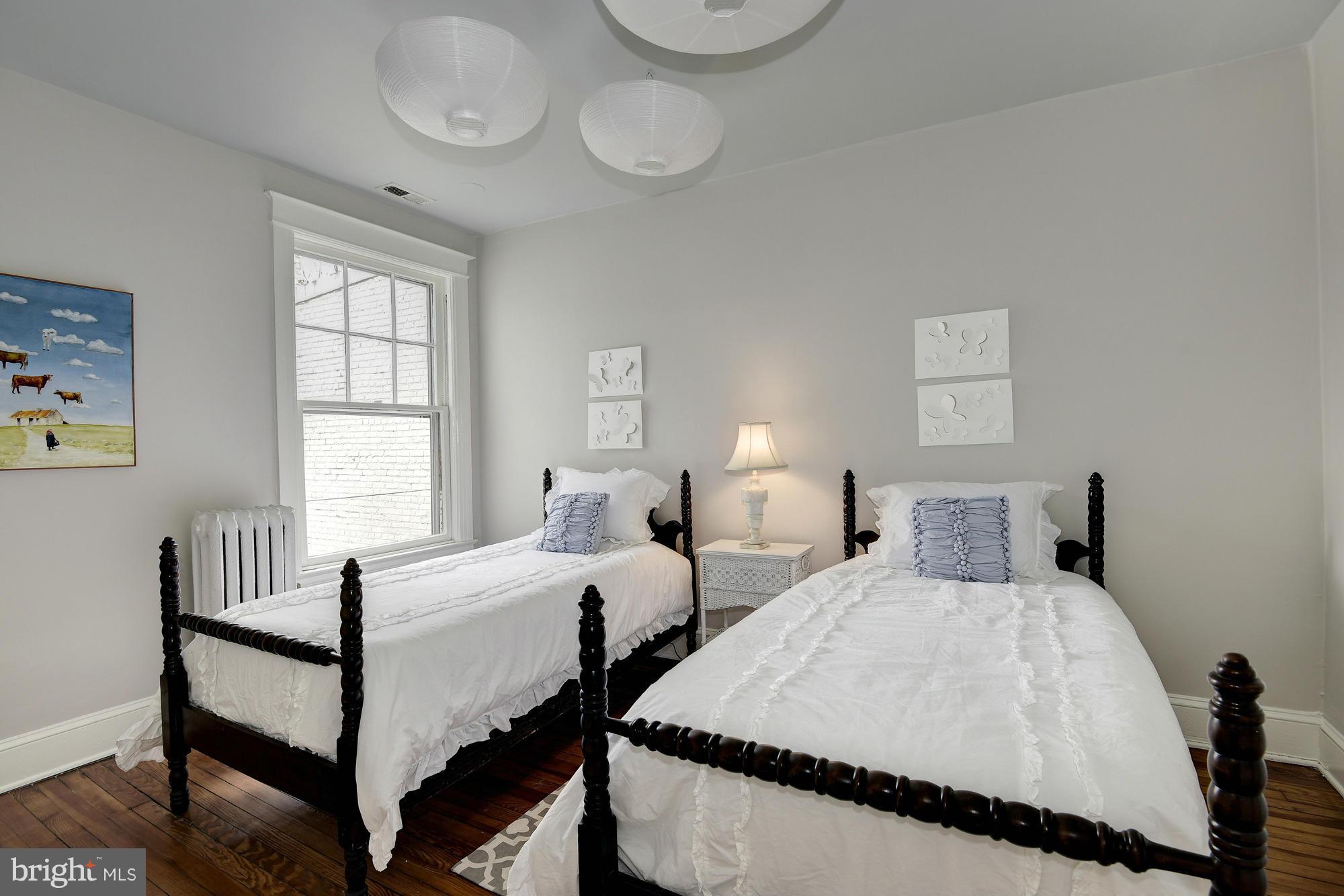 1351 A Street Northeast Washington, DC 20002 - Photo 16 of 26 a bedroom with two beds and a window