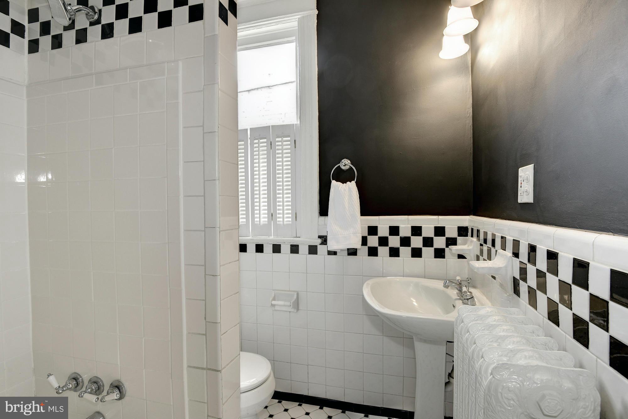 1351 A Street Northeast Washington, DC 20002 - Photo 17 of 26 a bathroom with a sink toilet and mirror