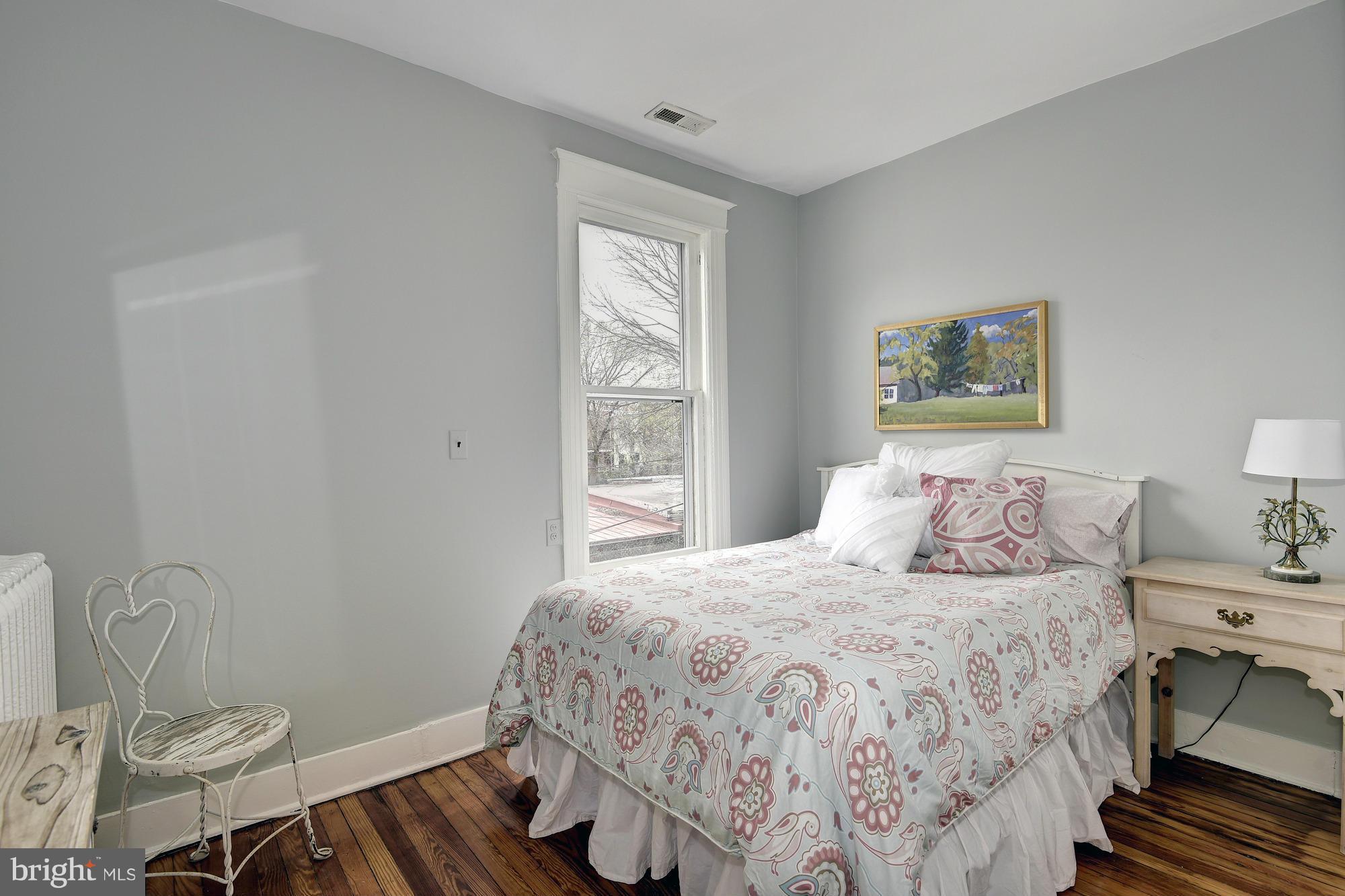 1351 A Street Northeast Washington, DC 20002 - Photo 18 of 26 a bedroom with a bed and wooden floor